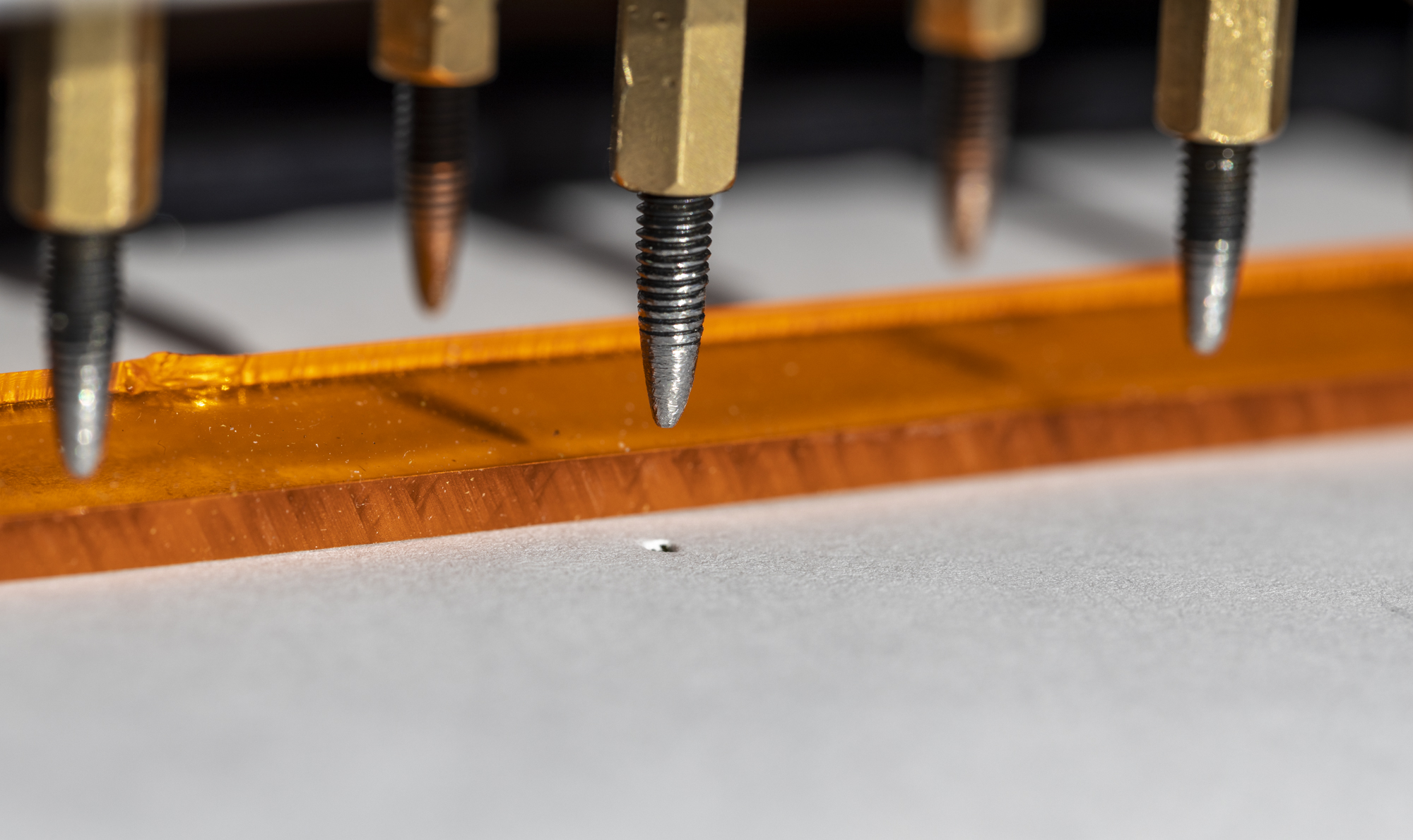 The Portabraille Printer solenoid tips punching a piece of paper